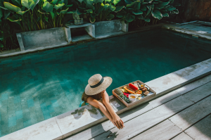 florida pool heat - girl in pool sitting relaxing