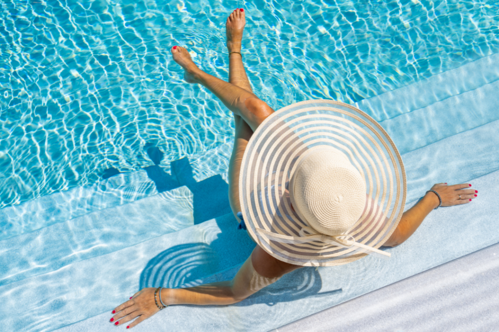 woman relaxing in pool with pool heater south florida